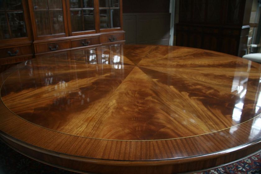 Large round mahogany table shown with 10 Chippendale chairs.