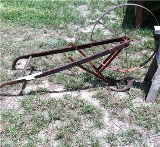 Antique plow walk behind very old yard art garden  